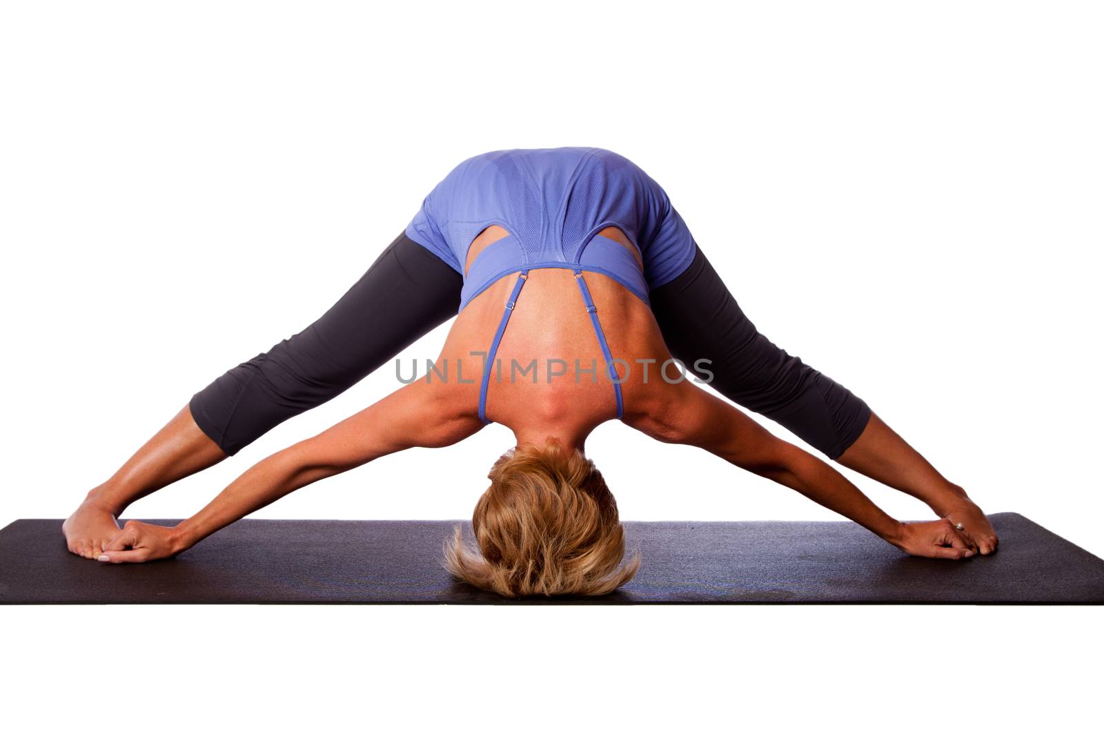 Beautiful healthy woman doing inversion Standing Intense Spread Leg Prasarita Padottanasana yoga pose with head on floor, on white.