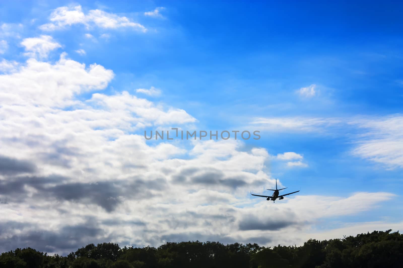 airplane flying at blue sky by Tetyana