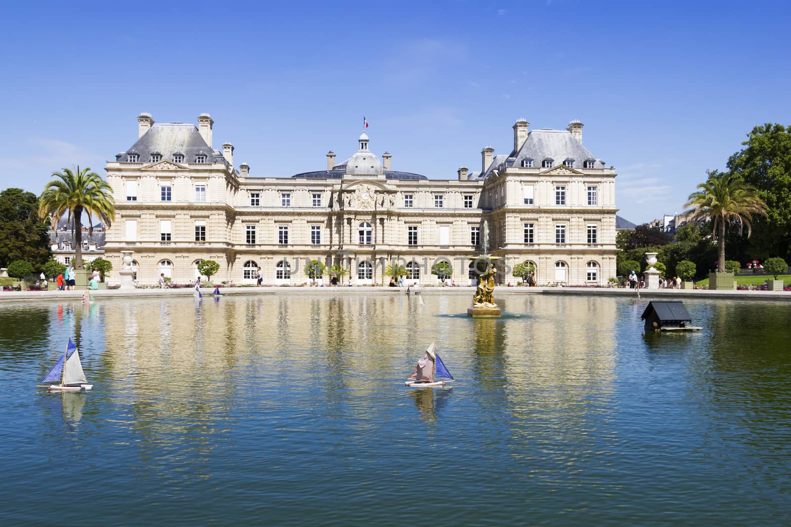 Traditional small wooden sailing boat in the pond of park Jardin du Luxembourg, Paris, France