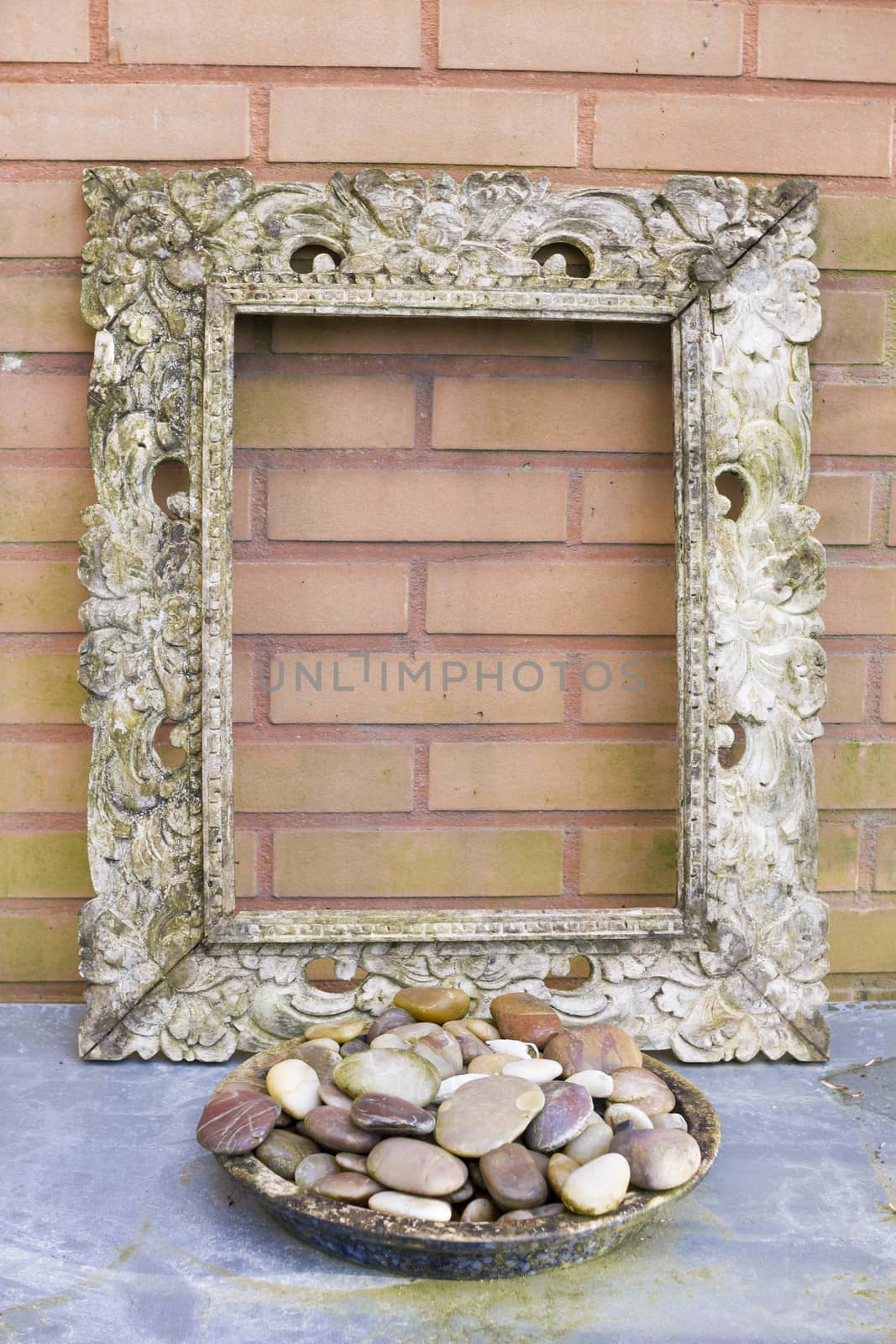 Wooden picture frame against  a brick background by Tetyana