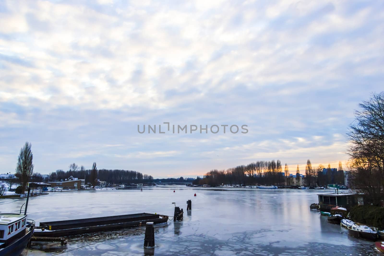 Frozen Amstel river in wintertime in Amsterdam, the Netherlands by Tetyana