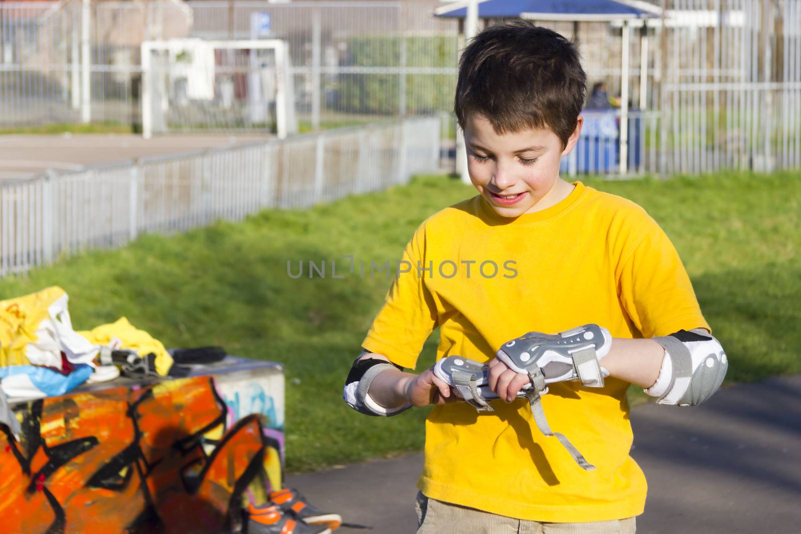 The boy puts on intently roller protection kit