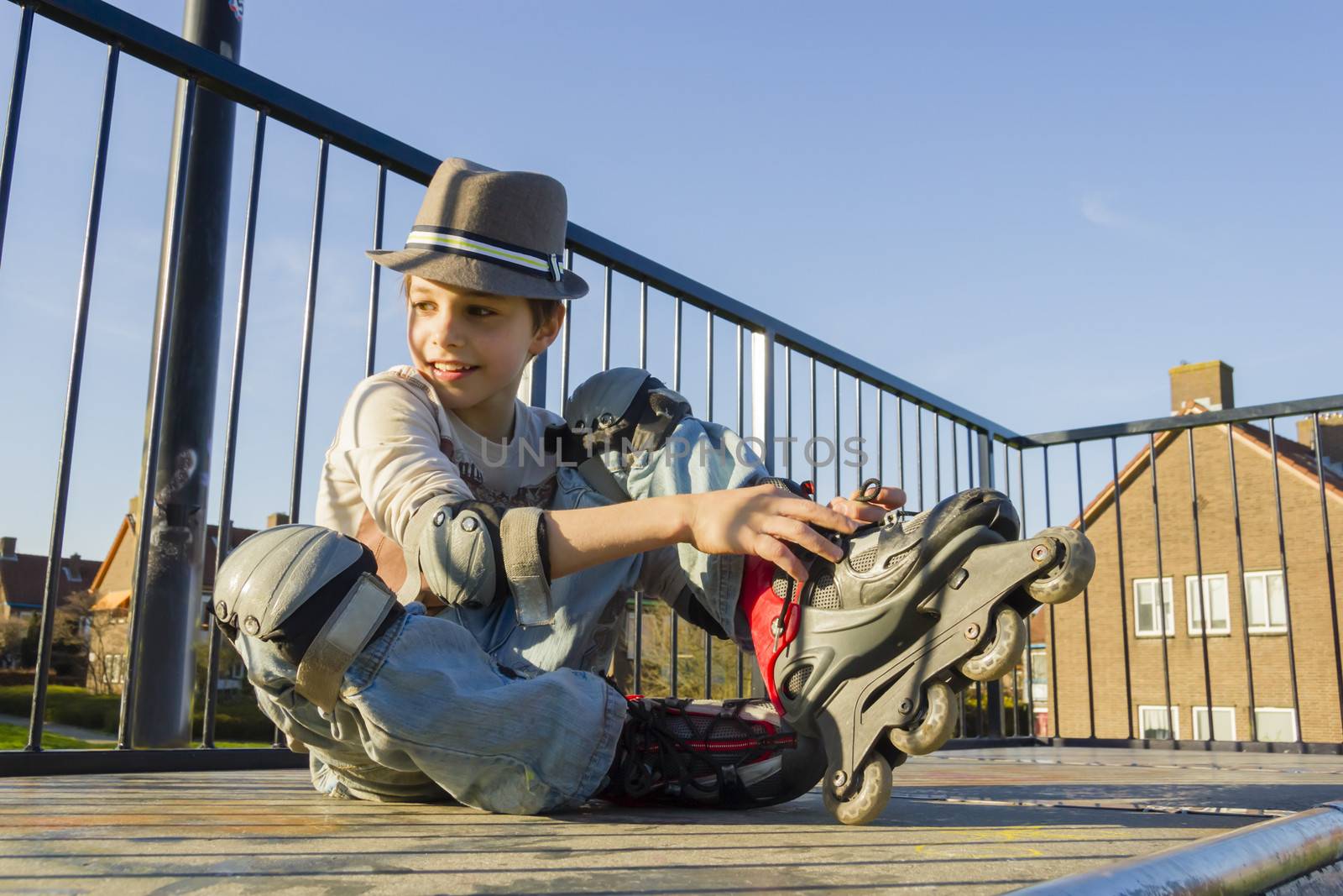 smiling teenage boy in roller-blading protection kit