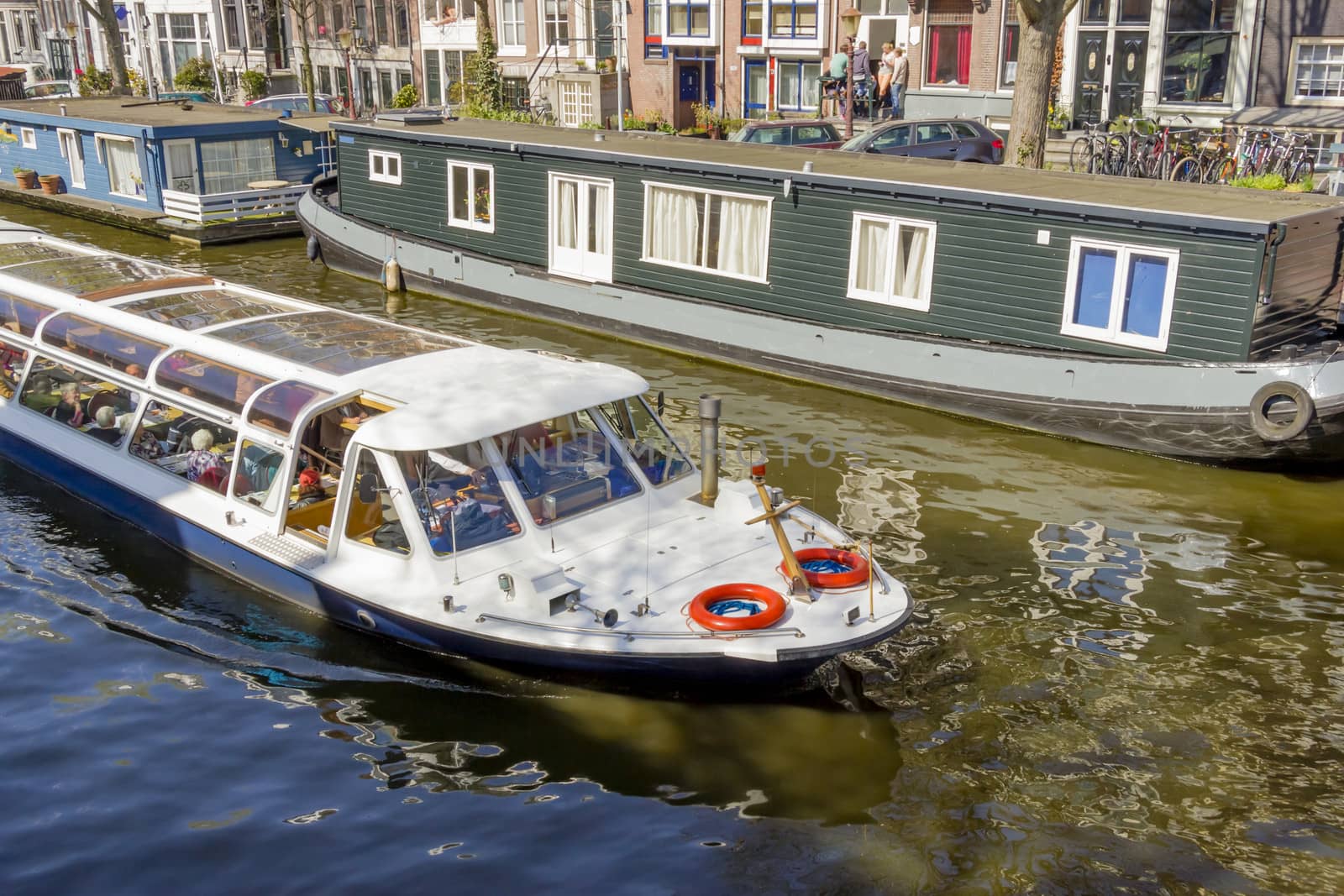 View on the houseboats with cruiseboat in Amsterdam the Netherlands