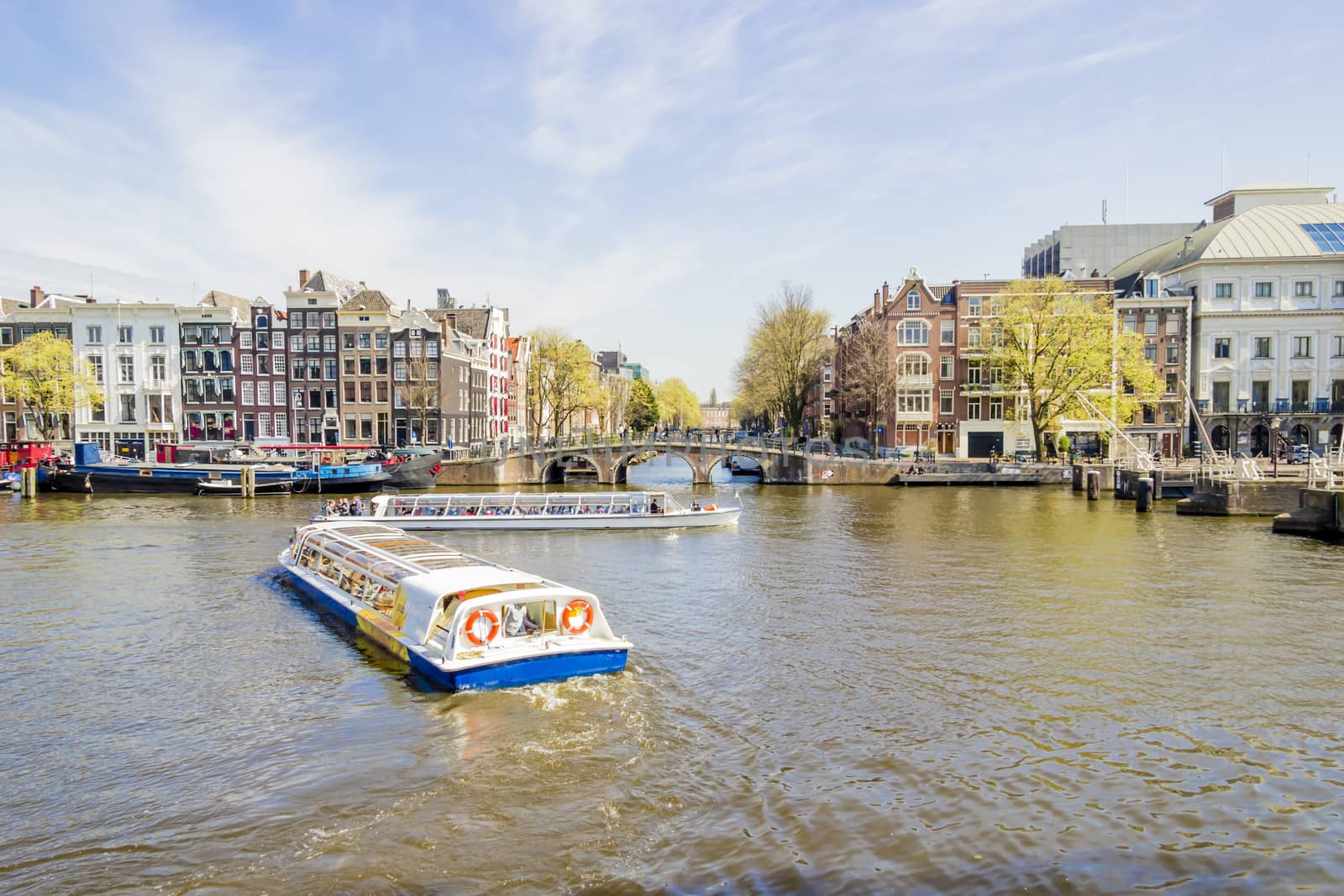 View on the houseboats with cruiseboat in Amsterdam the Netherlands