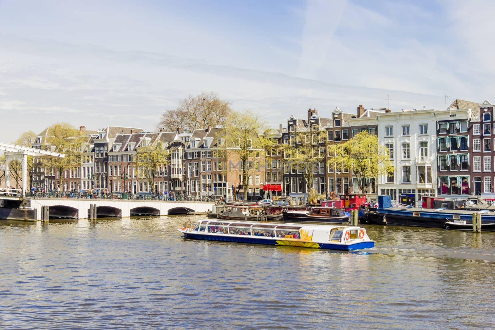 View on the houseboats with cruiseboat in Amsterdam the Netherlands