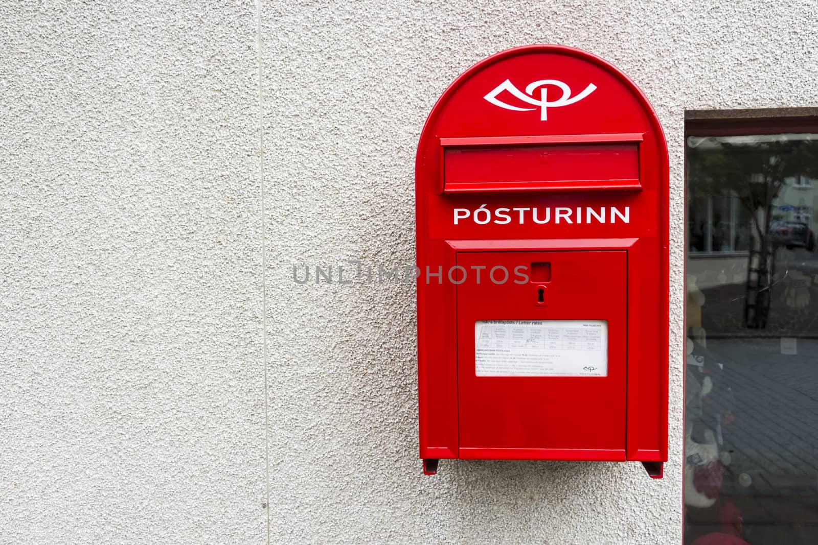 Modern red Mailbox in Iceland. Horizontal shot by Tetyana