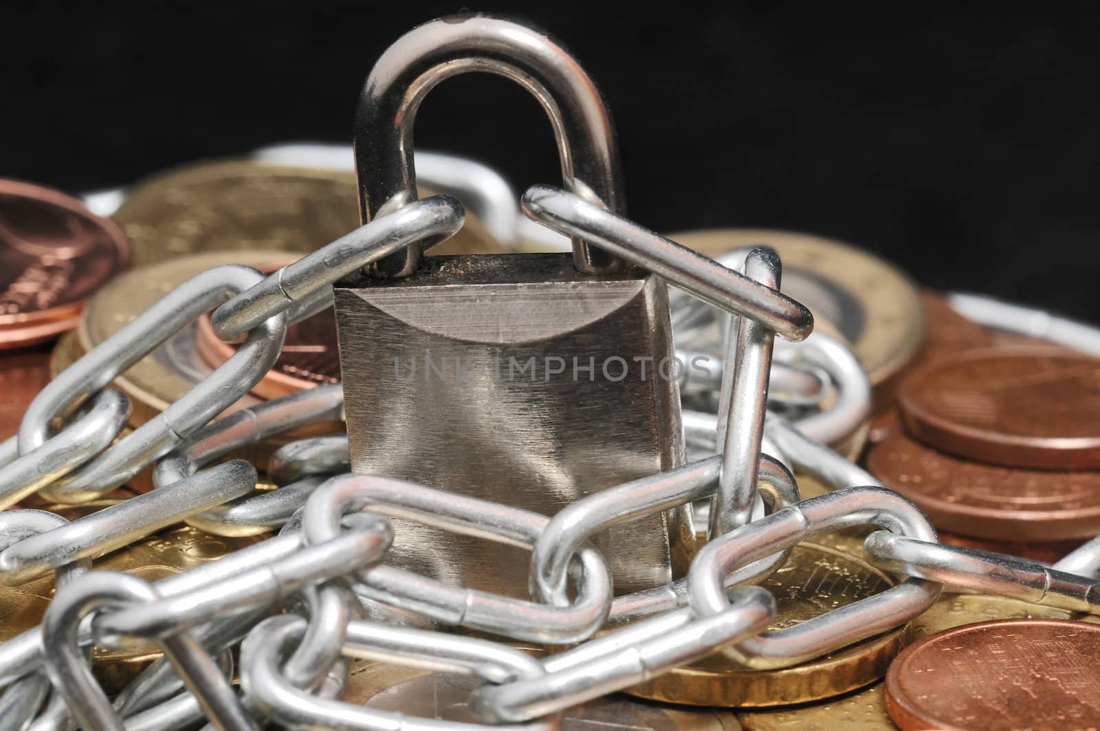 Secure Savings - a Lock and Some Coins on a Black Background