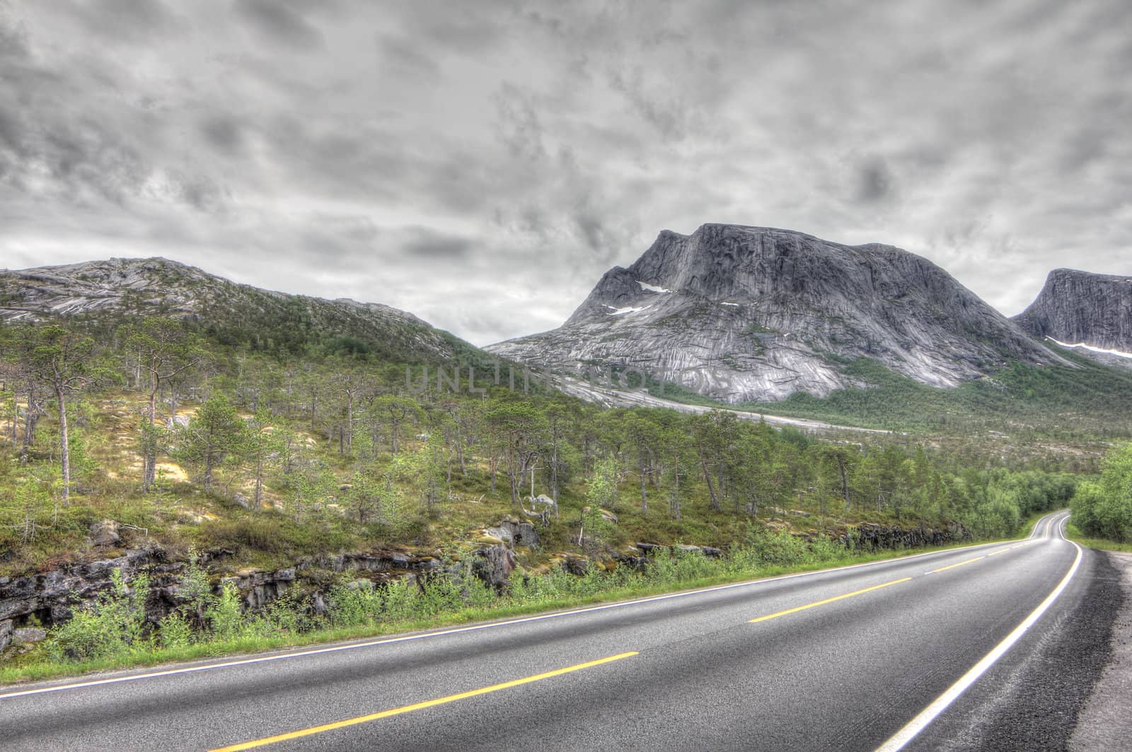 Norwegian landscape with road in tundra and mountains