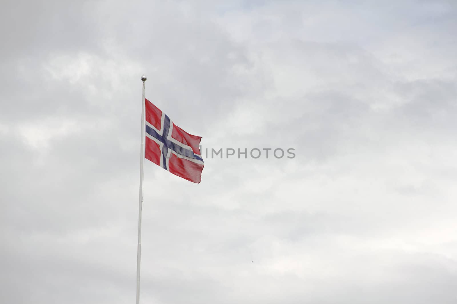 Norway Flag on cloudy sky background