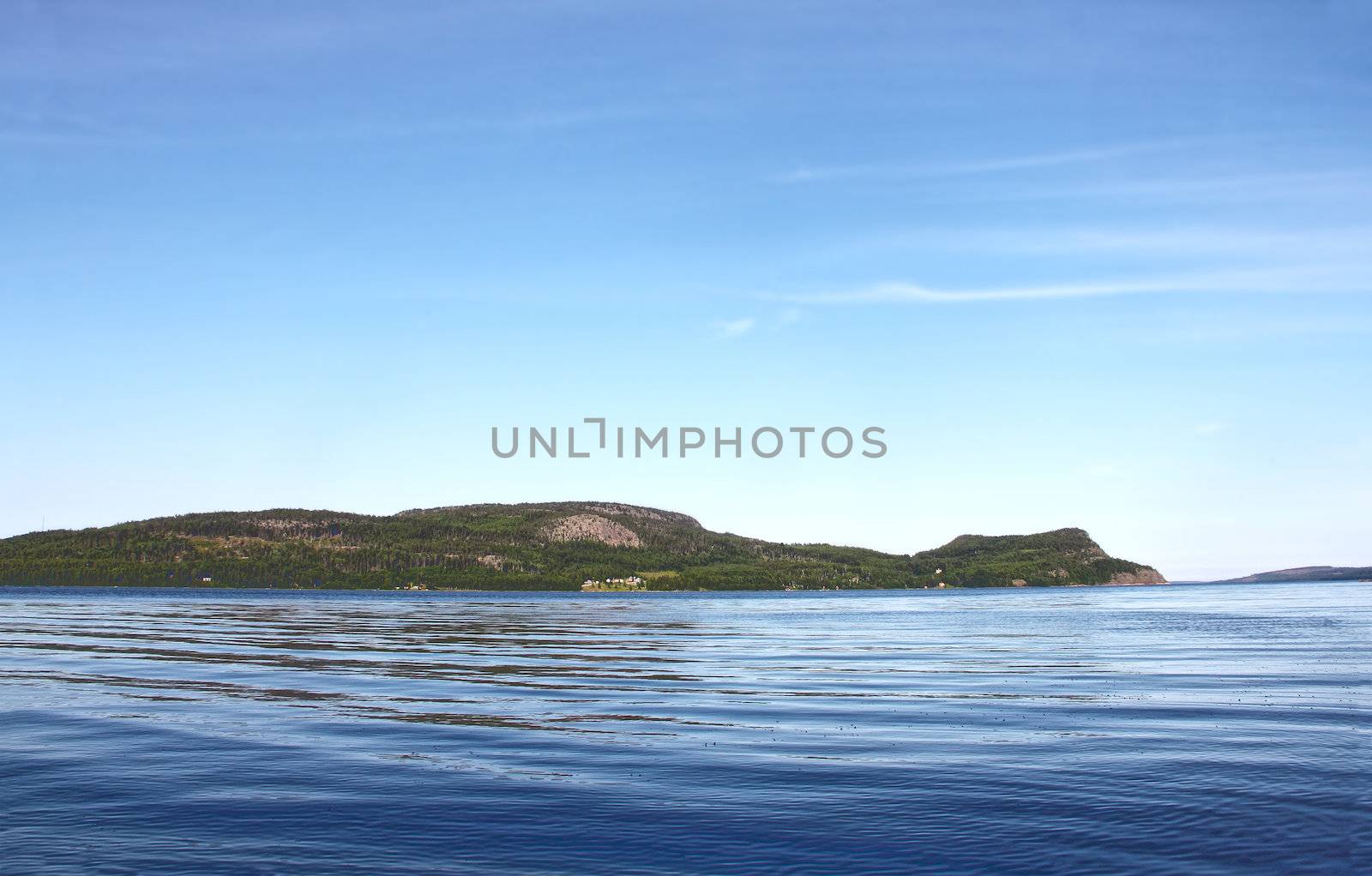 View on Norwegian fjord and mountain range at sunny day