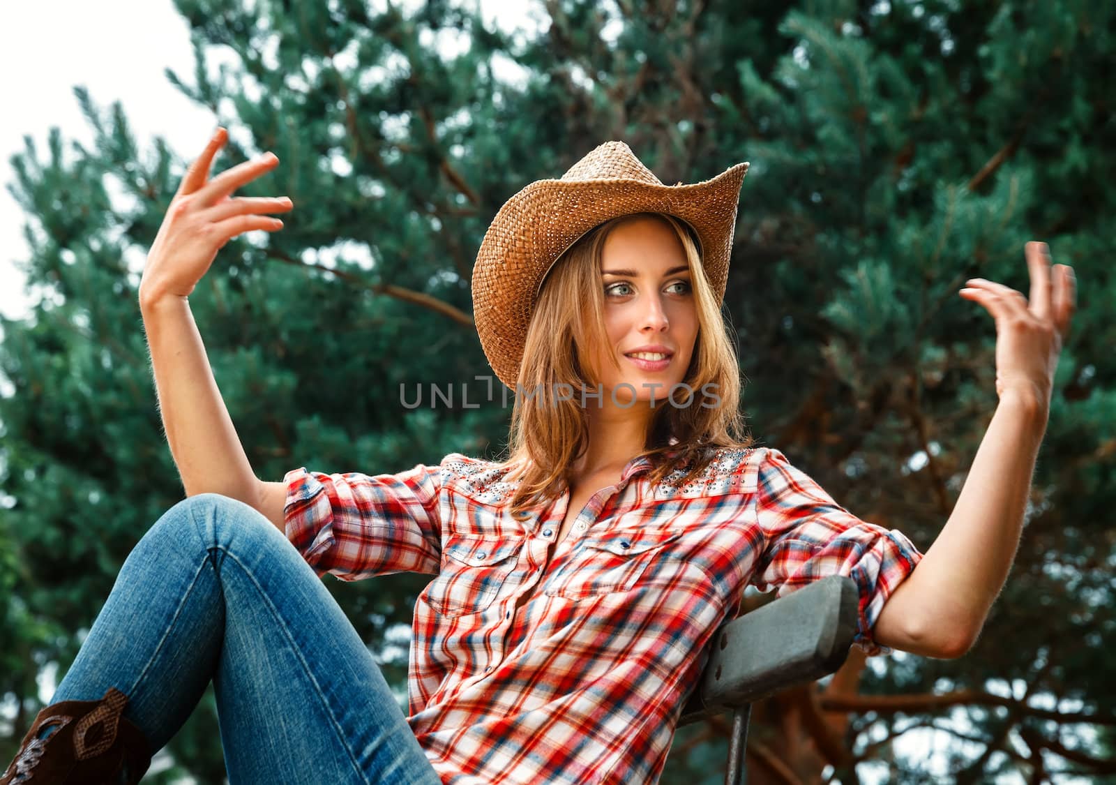 Sexy cowgirl. Young woman portrait in a hat