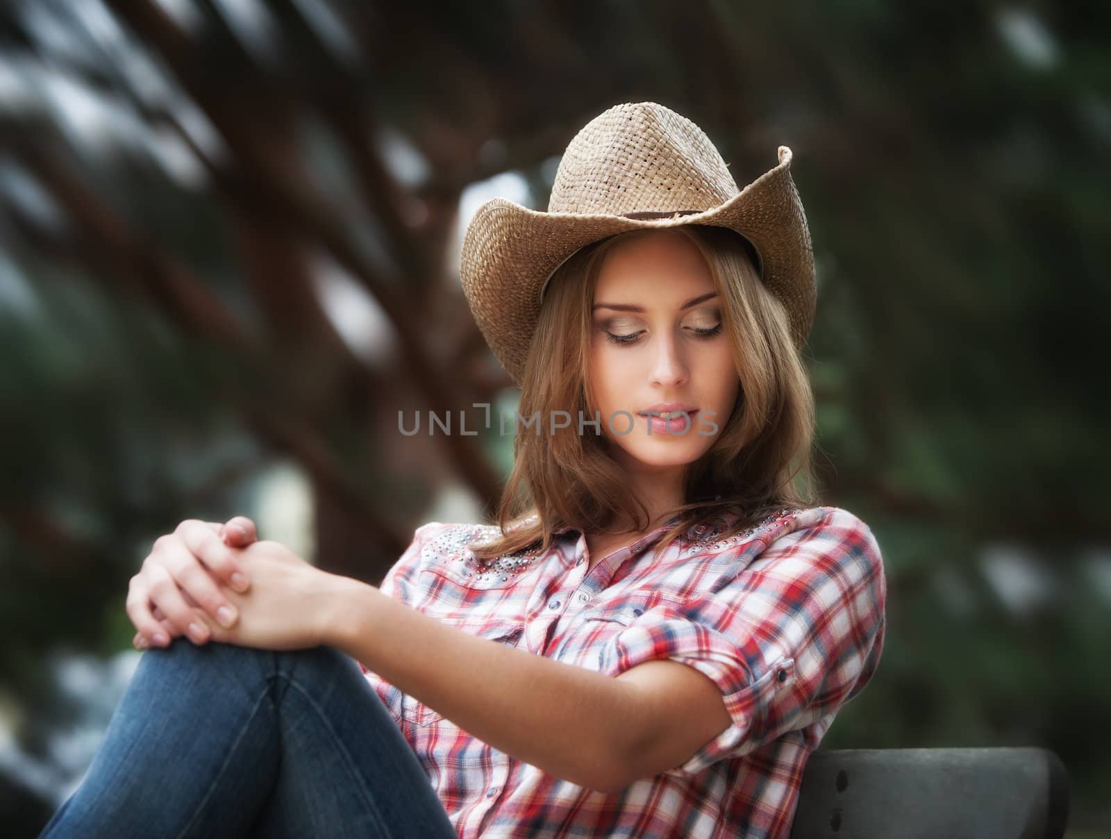 Soft portrait of sexy cowgirl. Young woman in a hat