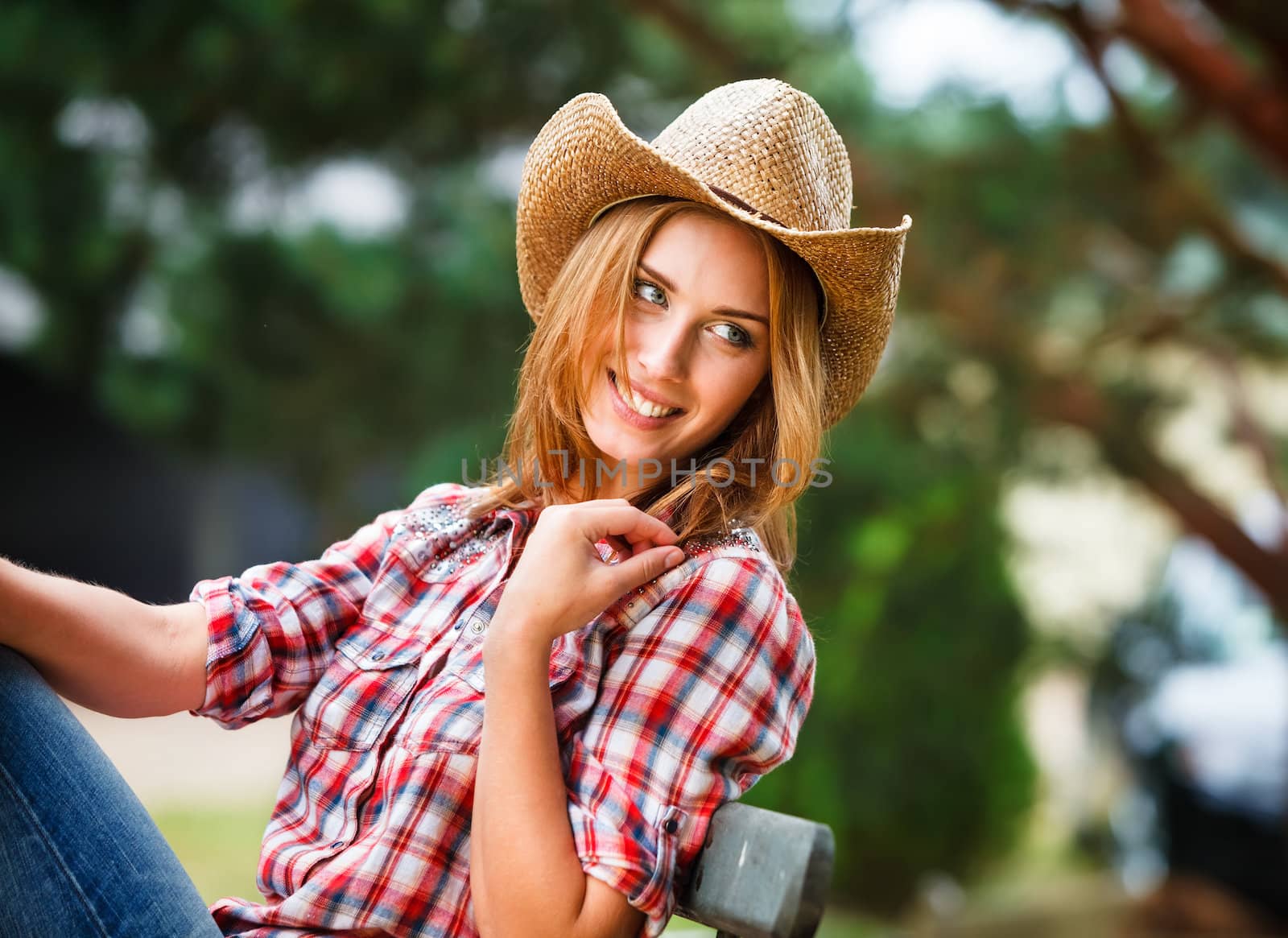 Sexy cowgirl. Young woman portrait in a hat