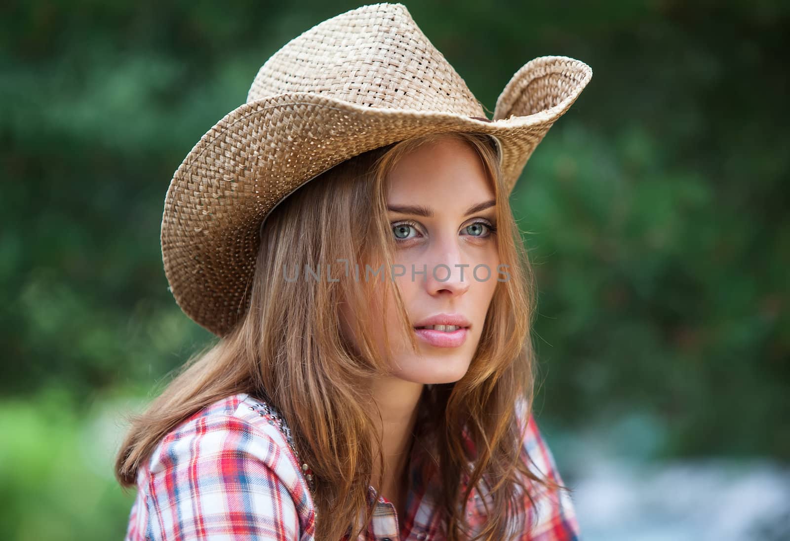 Sexy cowgirl. Young woman portrait in a hat