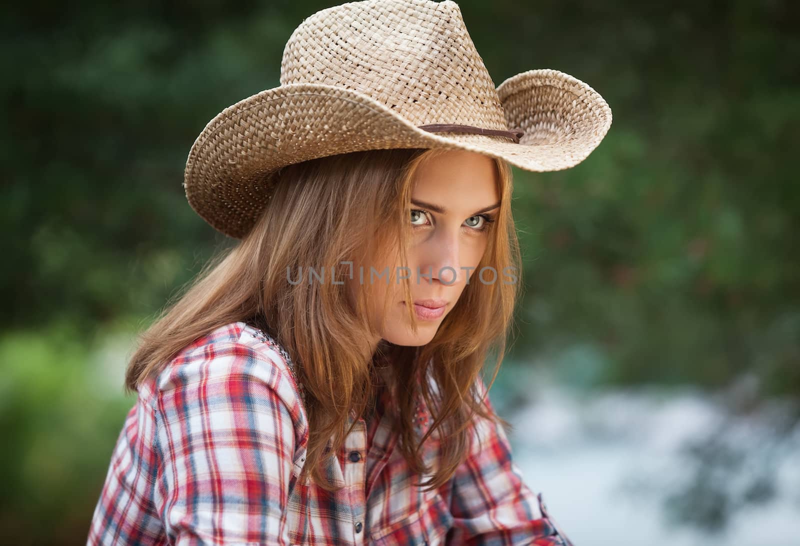 Sexy cowgirl. Young woman portrait in a hat