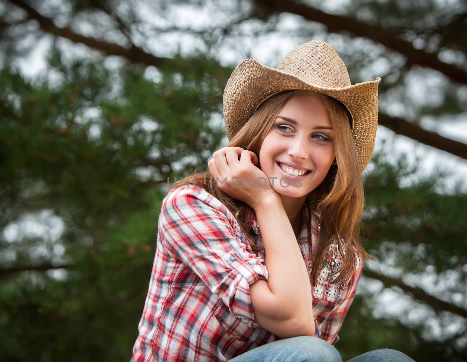 Sexy cowgirl. Young woman portrait in a hat