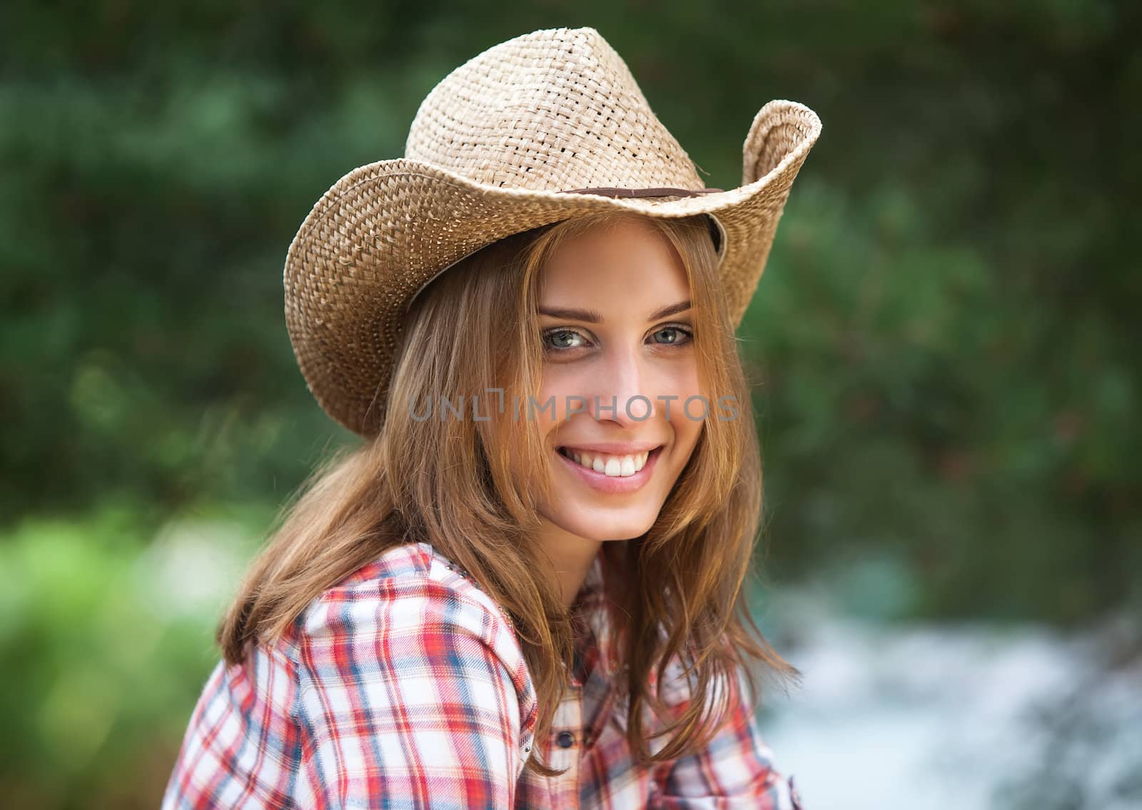 Sexy cowgirl. Young woman portrait in a hat