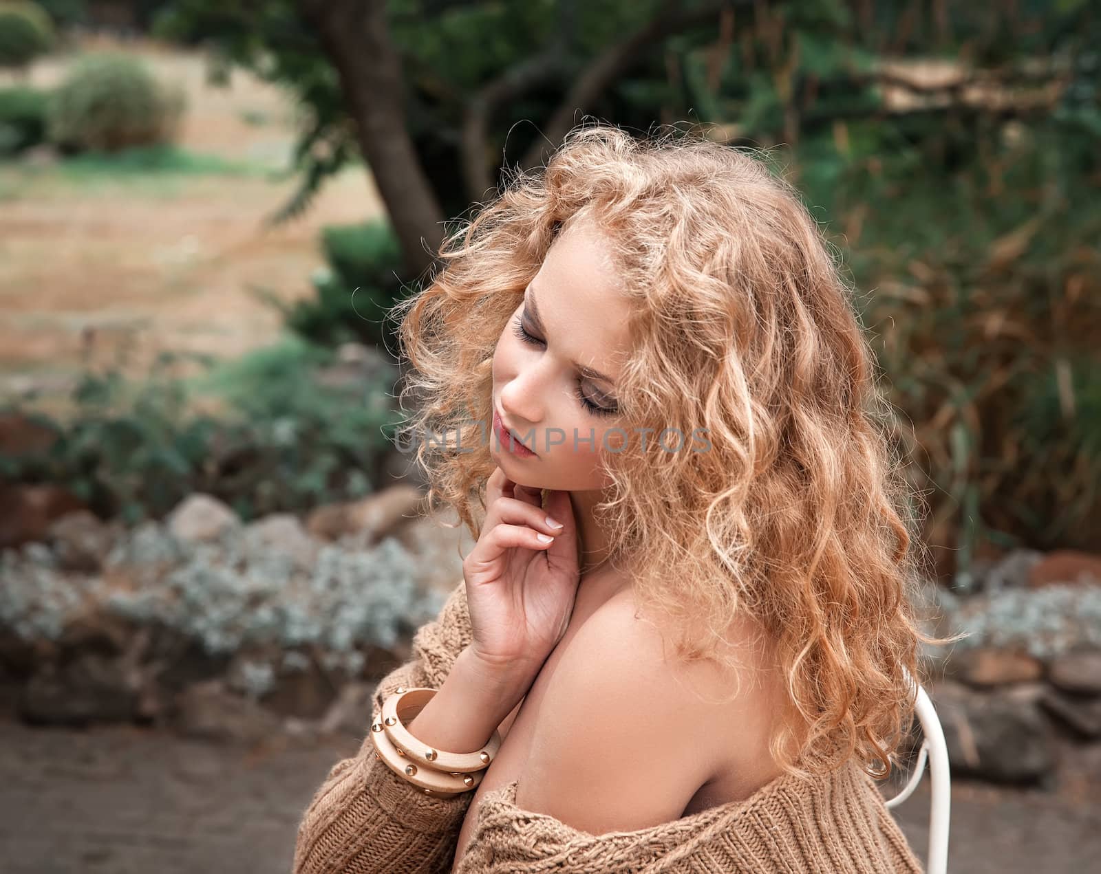 Beautiful woman resting in the garden by palinchak