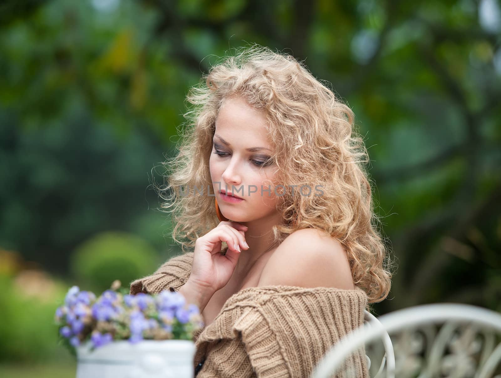 young beautiful woman is resting in the garden