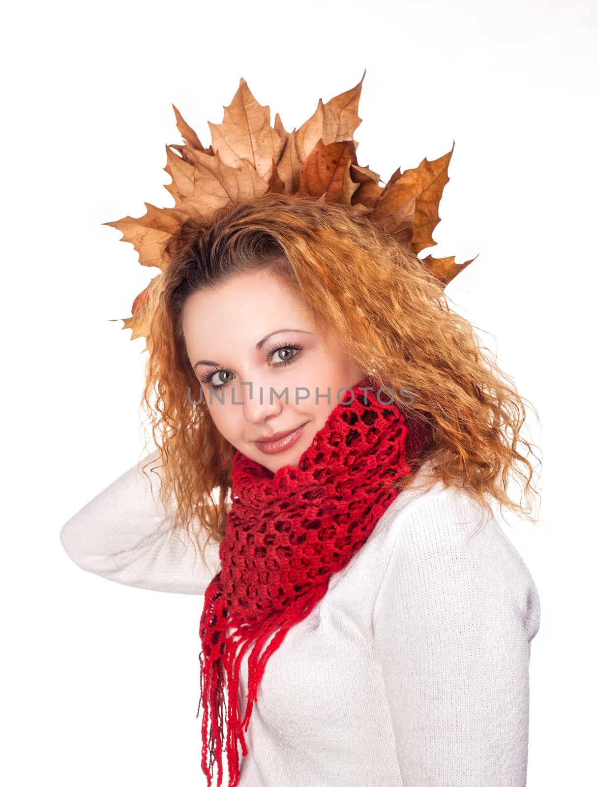 Redhead girl with dry autumn leaves on her head