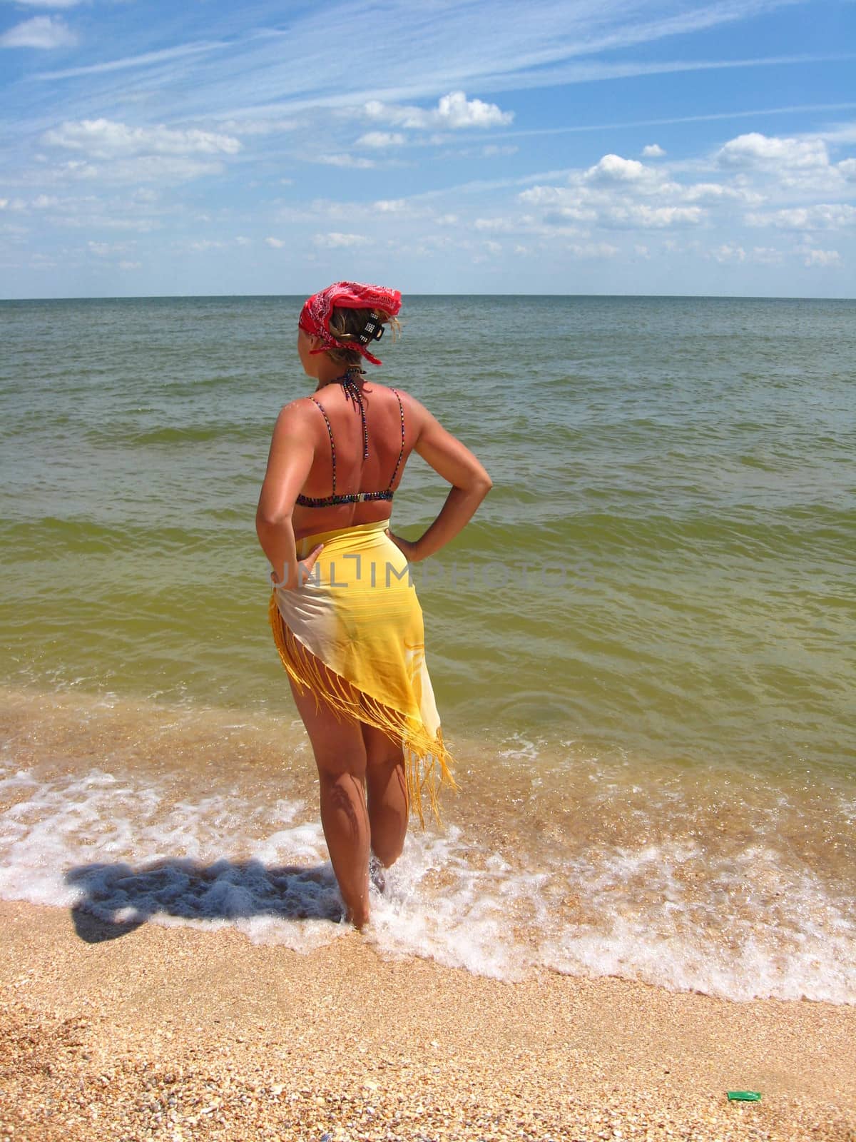 girl in bathing suit standing at the seacoast
