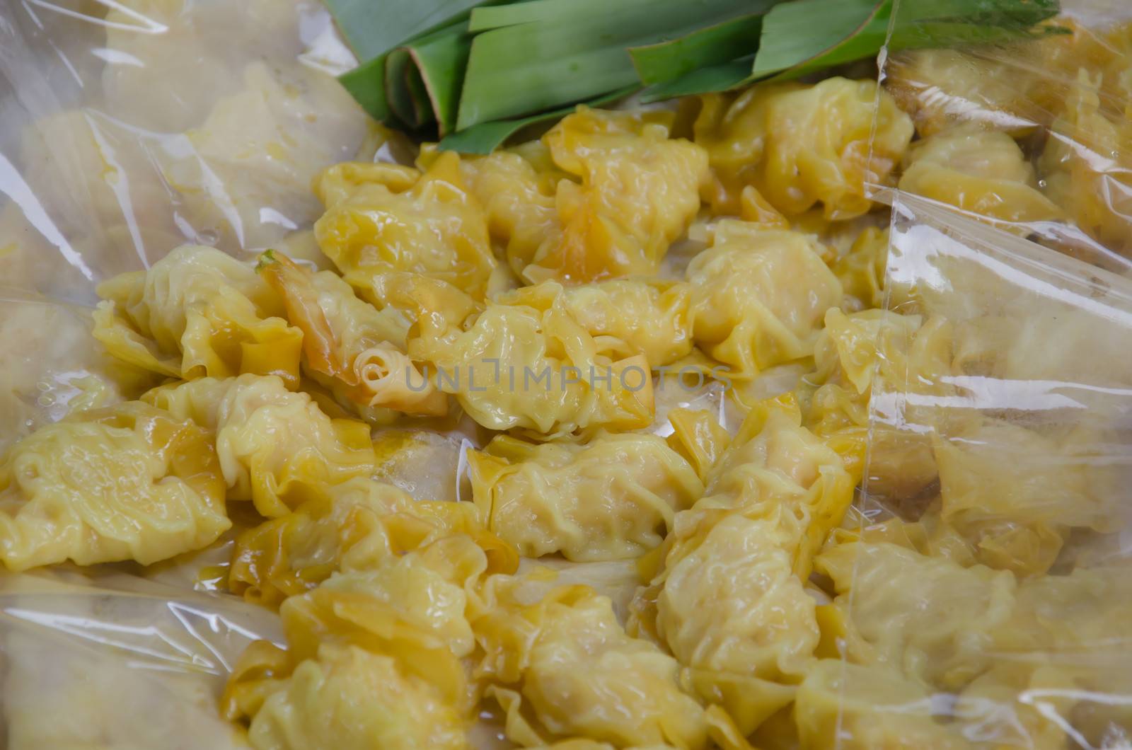 close up Chinese dumplings filled with pork and spring onions.