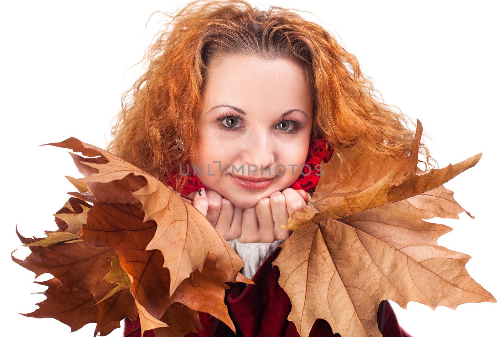 Redhead girl with dry autumn leaves