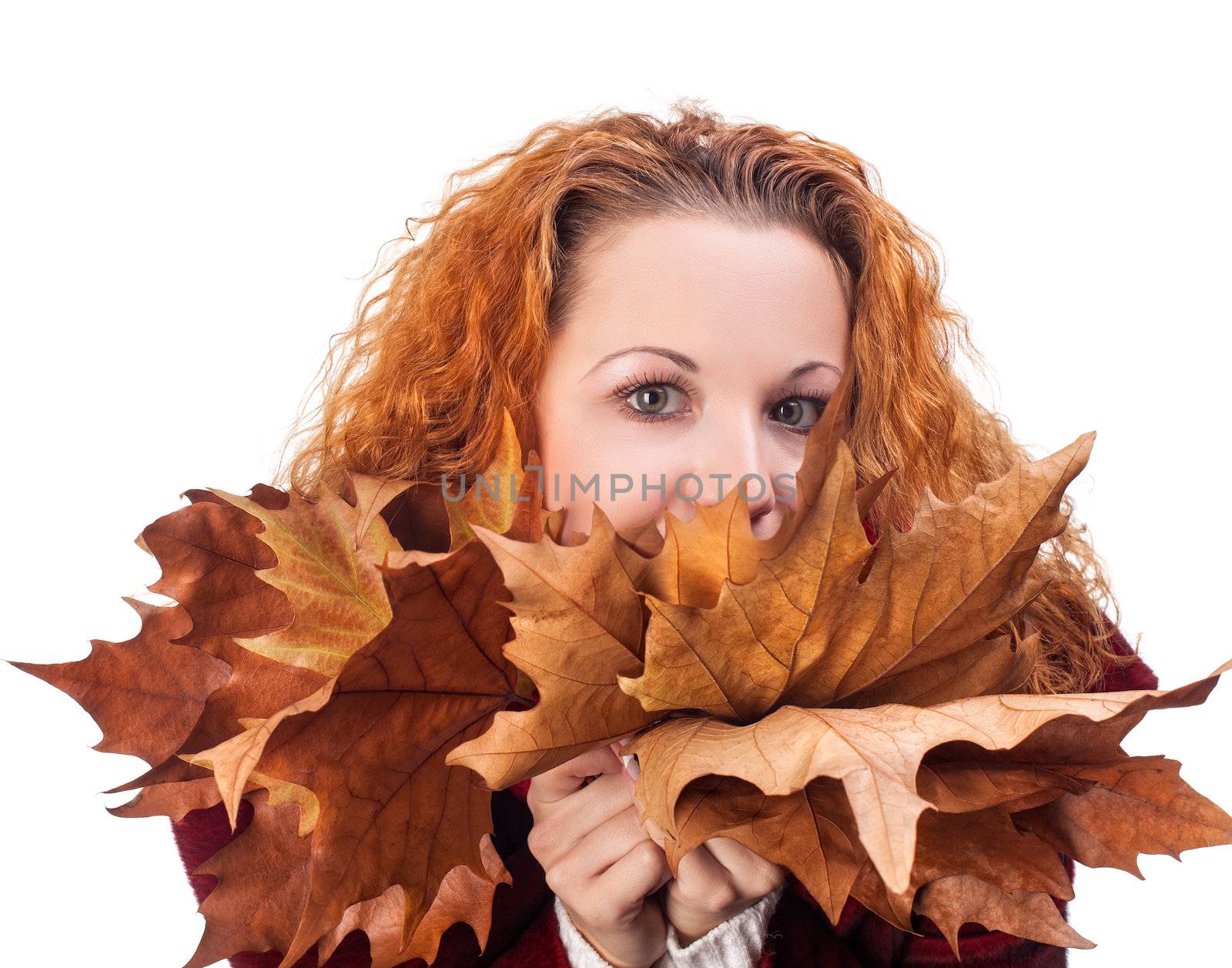 Redhead girl with dry autumn leaves