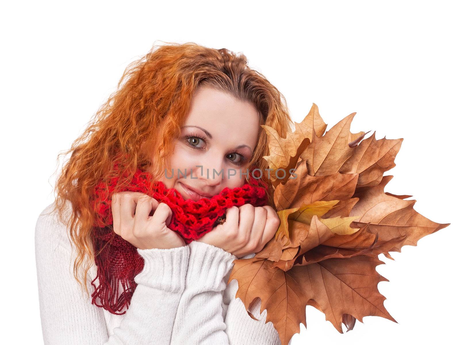 Redhead girl with yellow autumn leaves