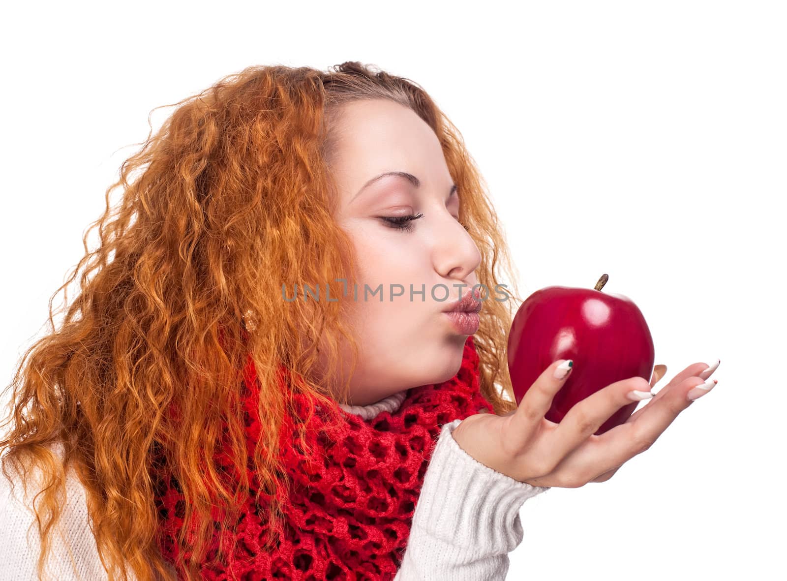 Red-haired girl with apple isolated on white