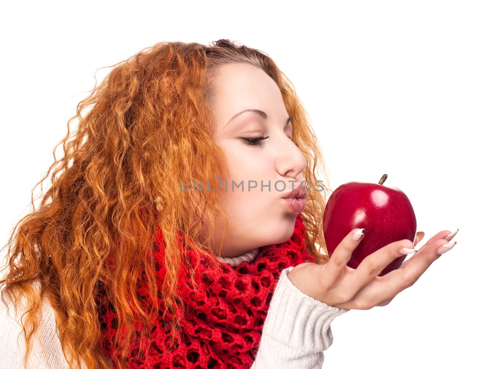 Red-haired girl with apple isolated on white