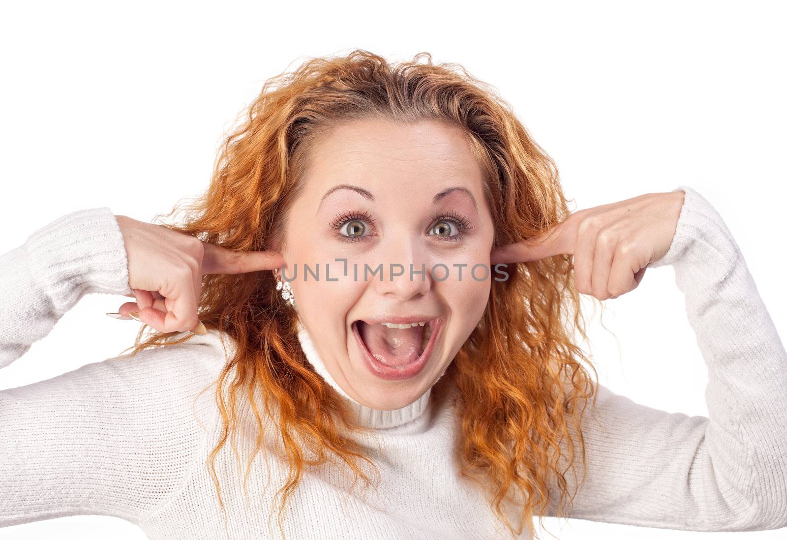 Surprised redhead  girl closes her ears by hands