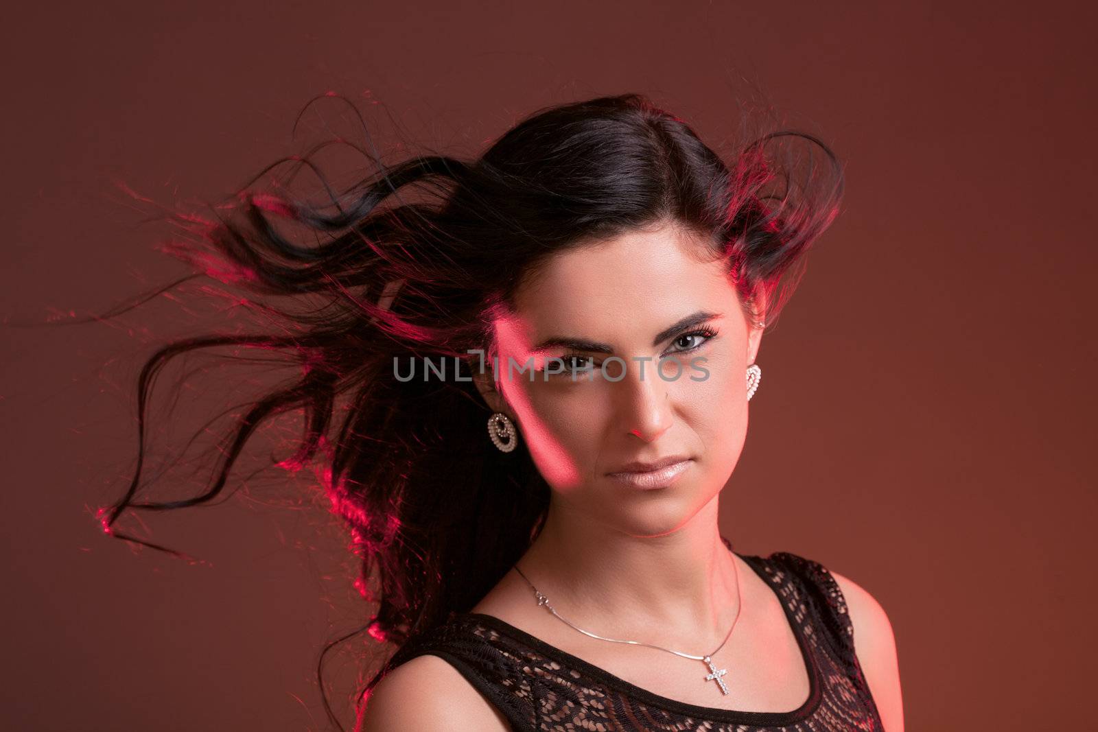 Portrait of a beautiful young woman with hair flying