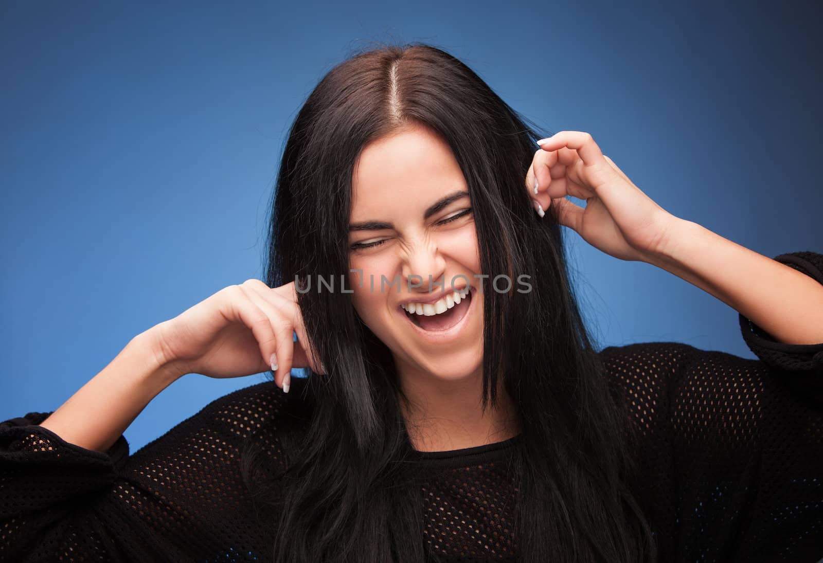 pretty girl closing her ears with fingers 