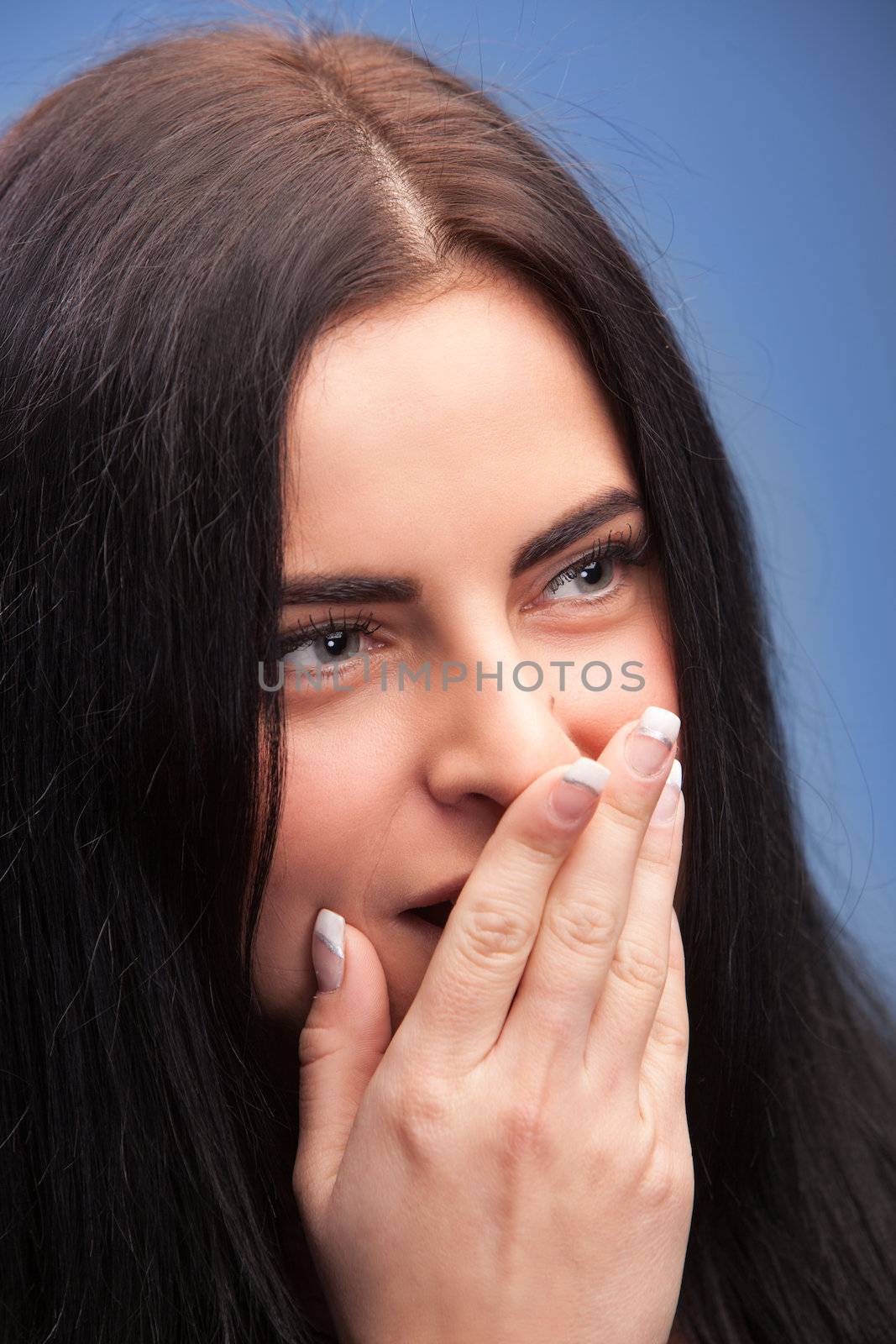 Surprise brunette girl over blue background