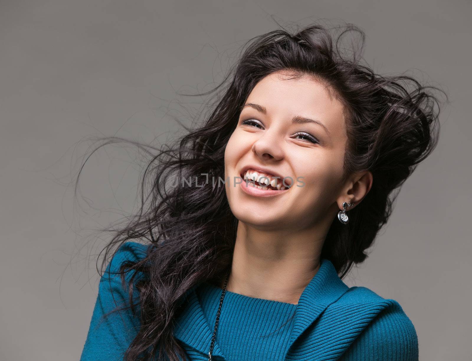 Portrait of a beautiful young woman with hair flying