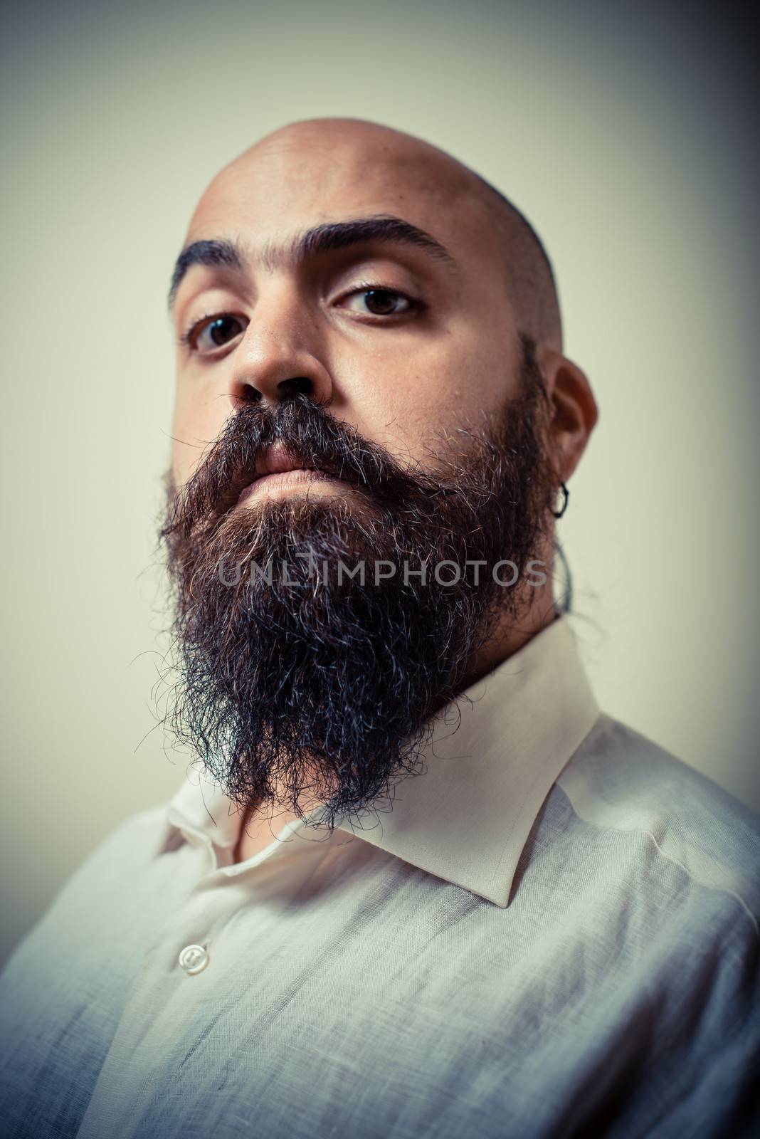 long beard and mustache man with white shirt on gray background