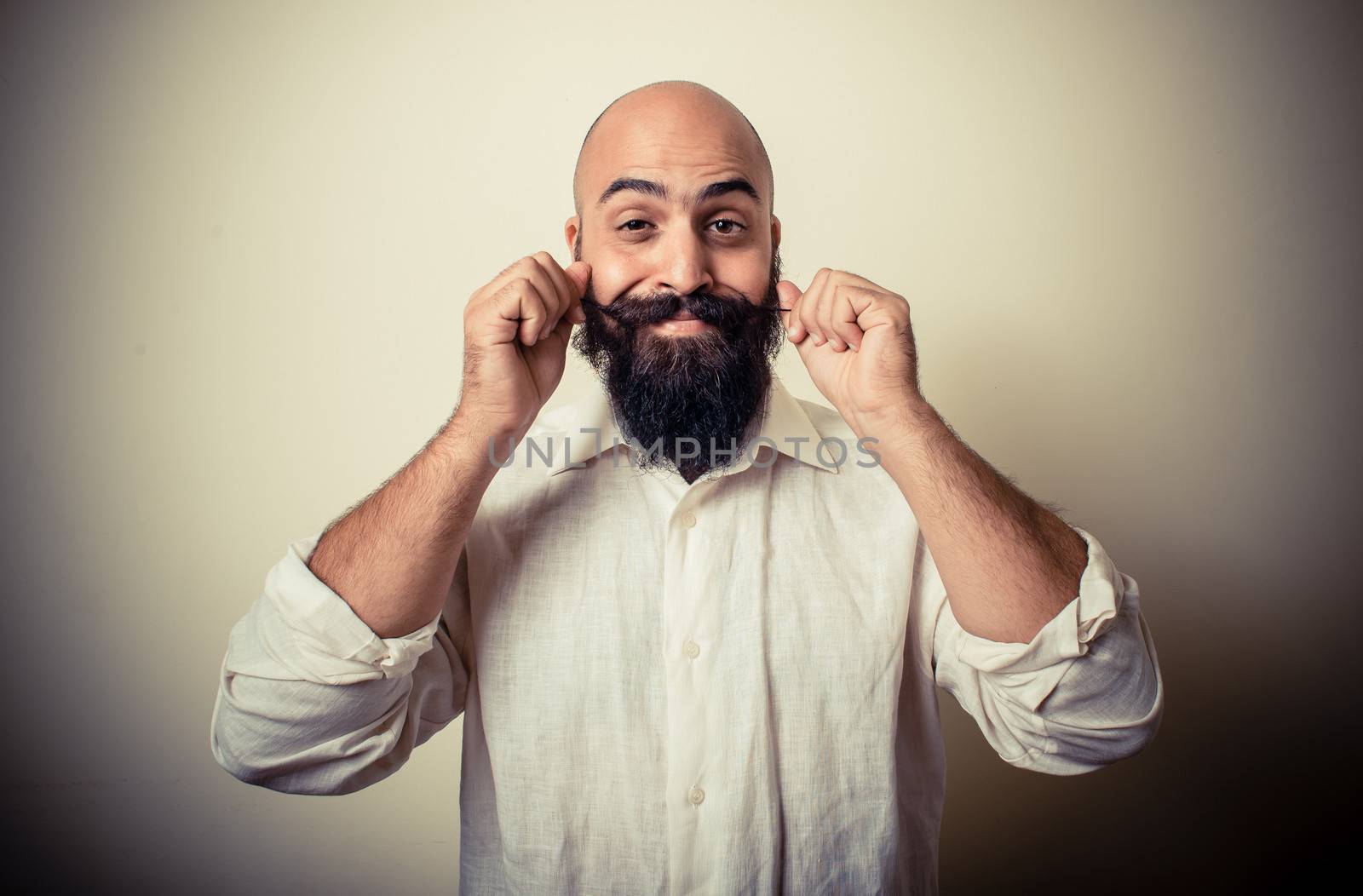 long beard and mustache man with white shirt on gray background