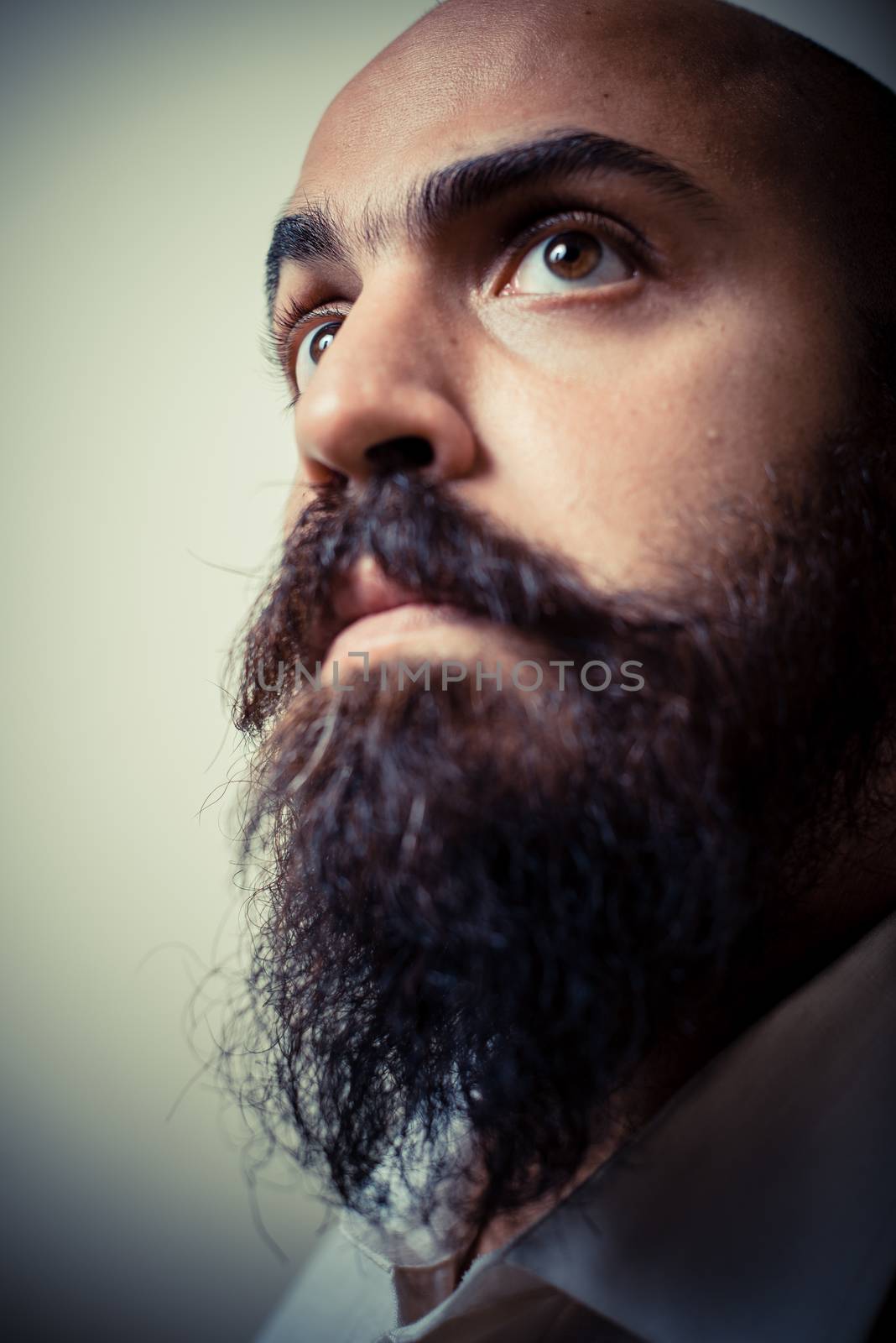 long beard and mustache man with white shirt on gray background