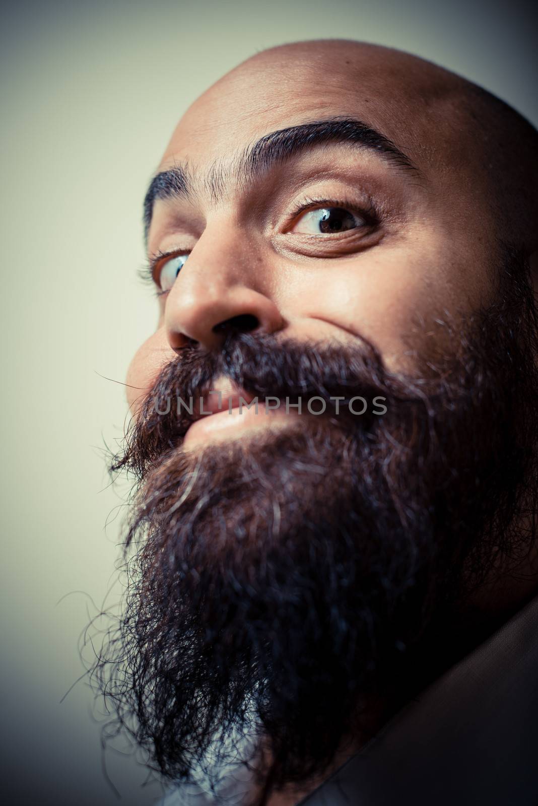 long beard and mustache man with white shirt on gray background