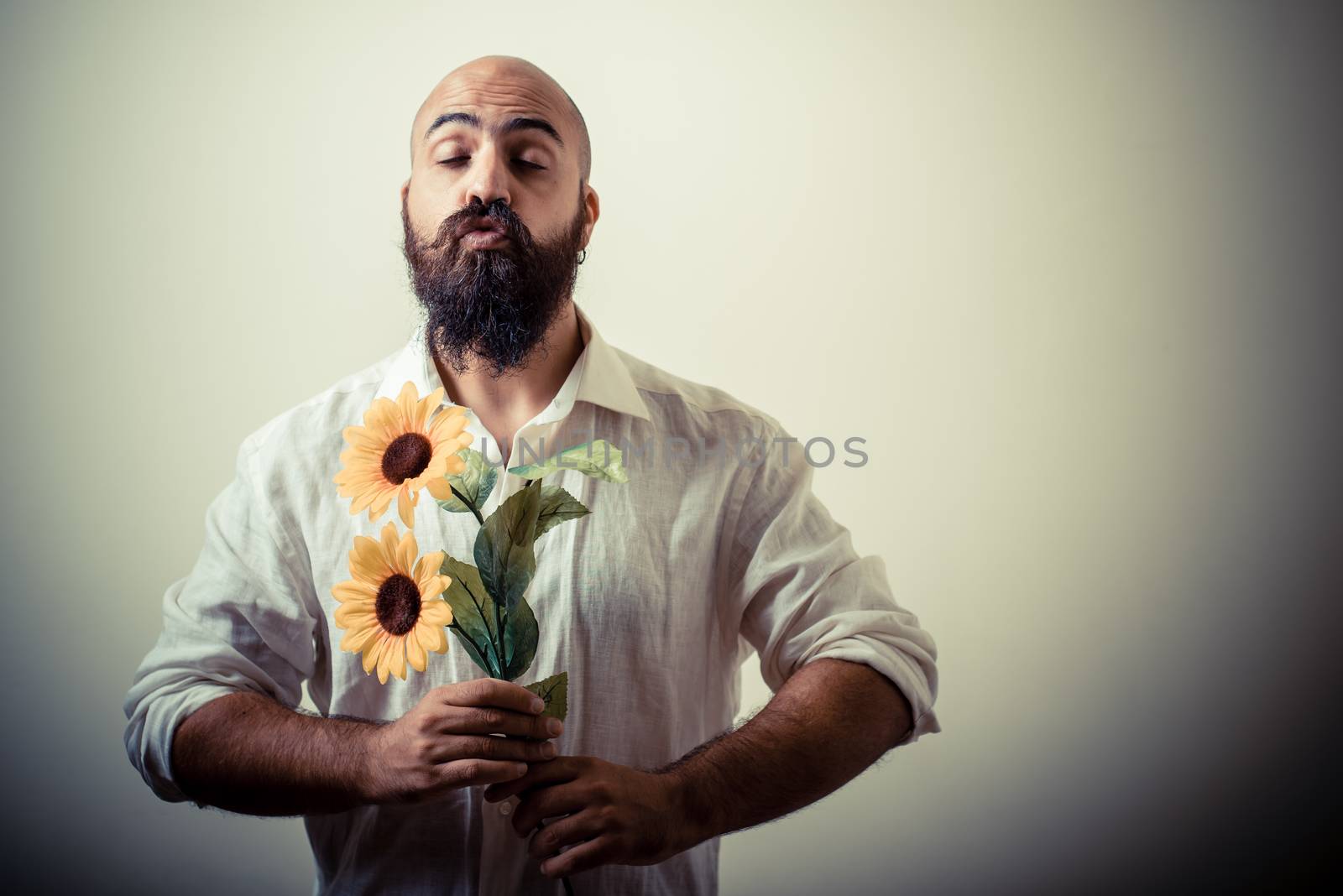 long beard and mustache man giving flowers by peus