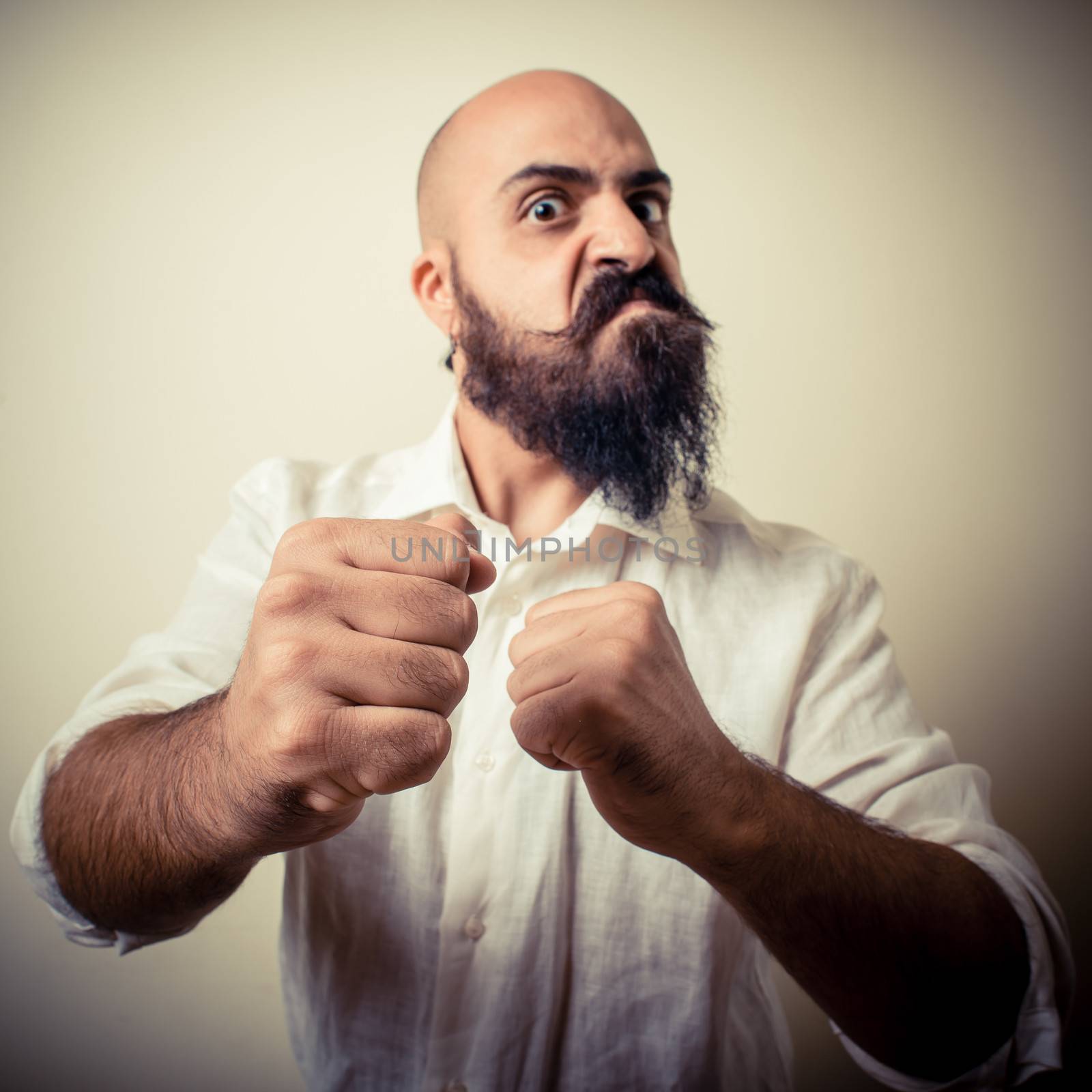 angry fighter long beard and mustache man  on gray background