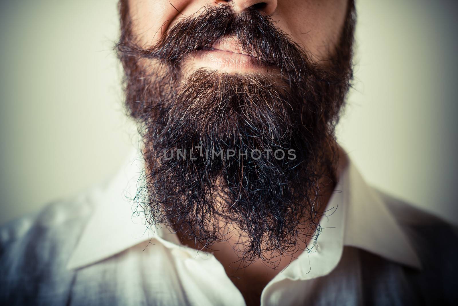 long beard and mustache man with white shirt on gray background