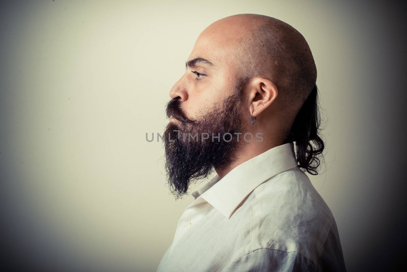 long beard and mustache man with white shirt on gray background