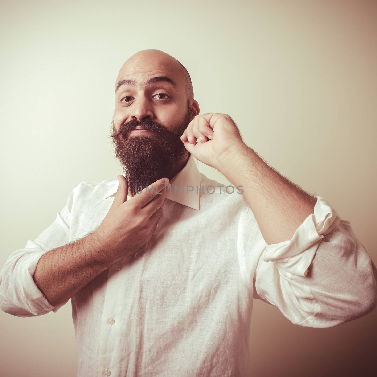 long beard and mustache man with white shirt on gray background