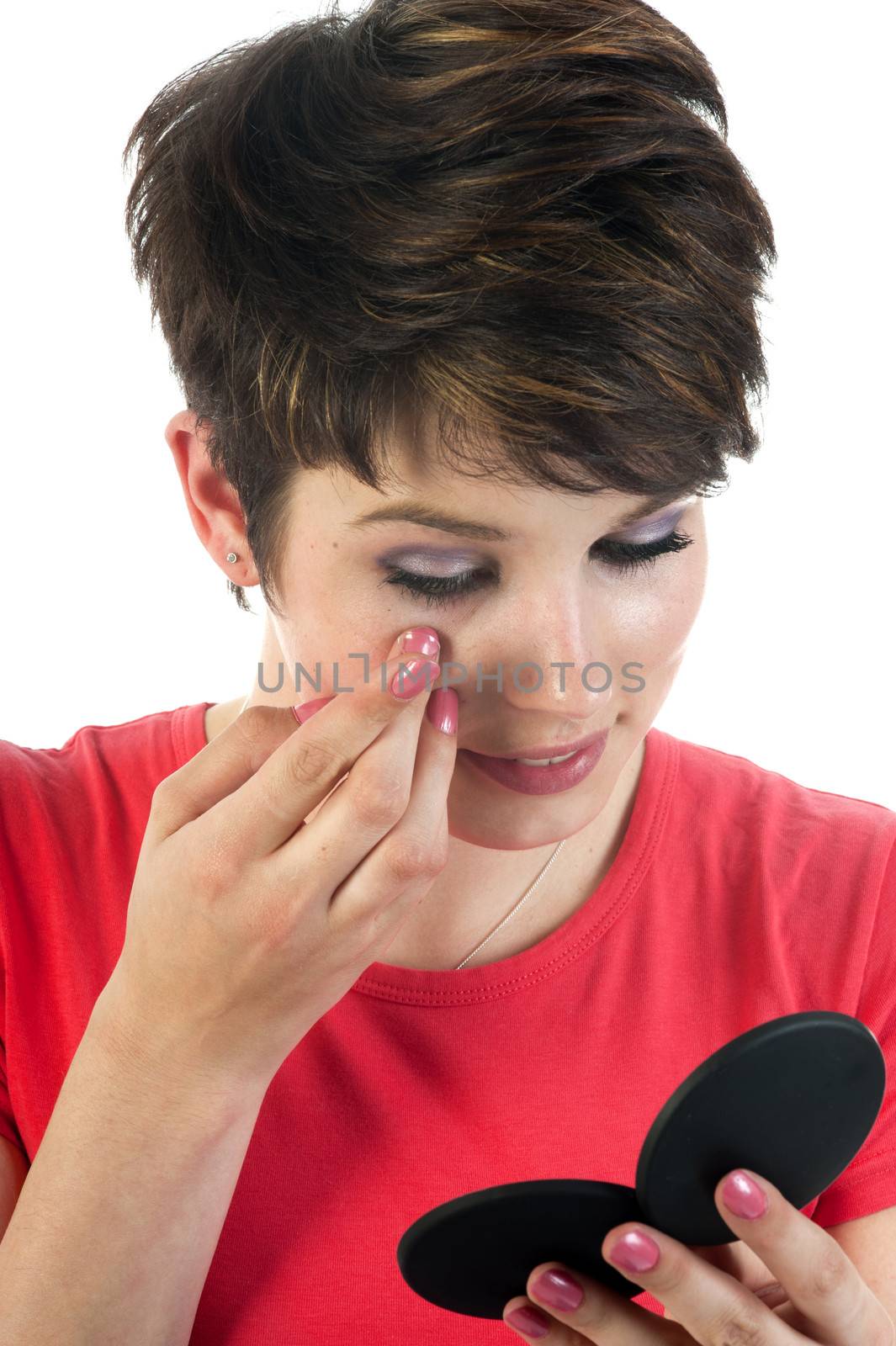 Closeup of a woman inserting a contact lens in her eye