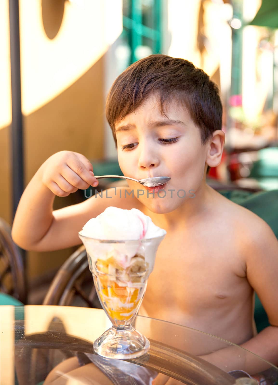 Portrait of 4-5 years old boy eating ice cream dessert