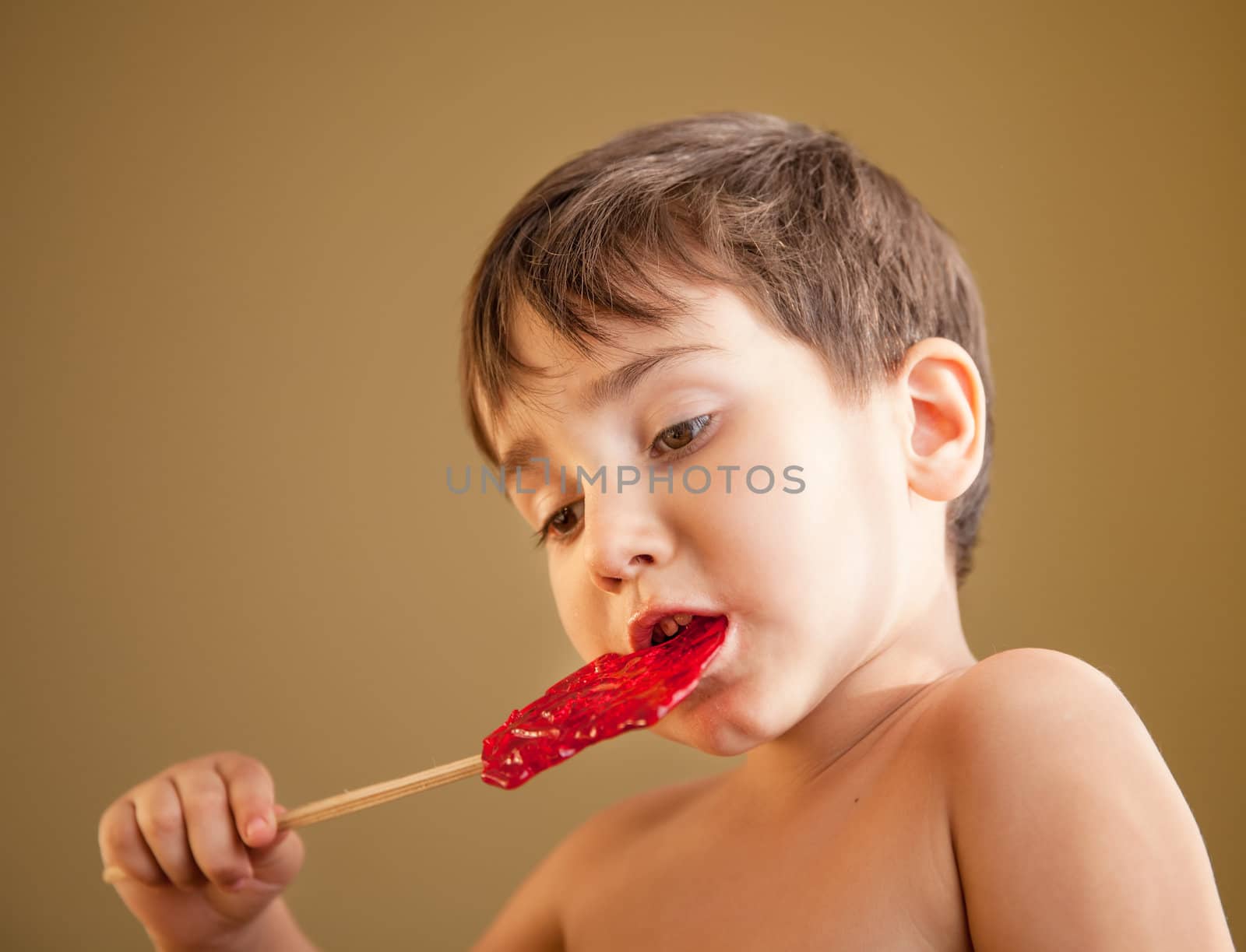 Close Up of Young Boy Eating A Lollipop