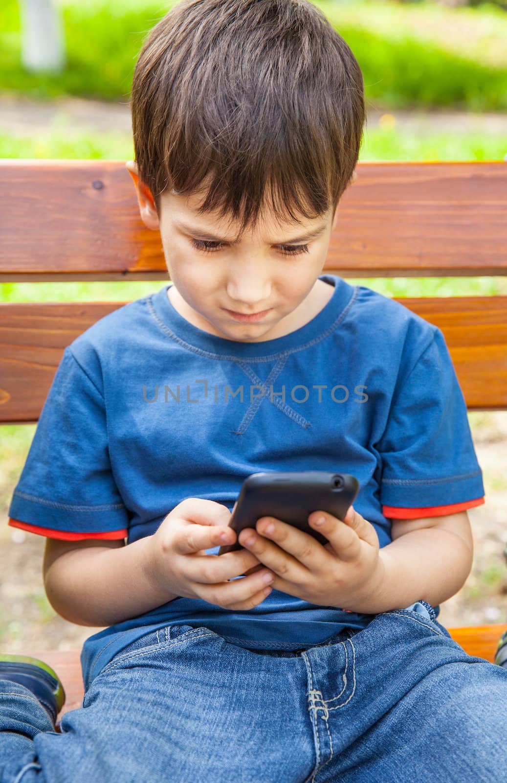 boy playing games on smartphone by palinchak